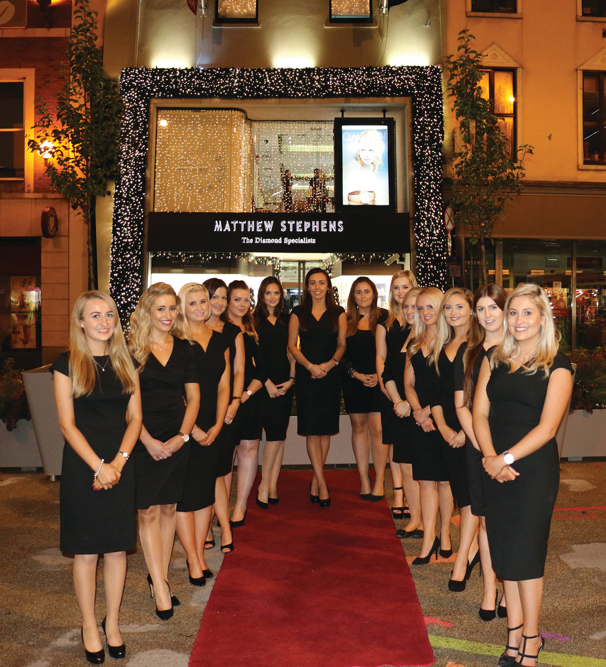 Staff in a line outside store
